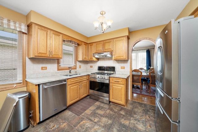 7542 Mason Ave, Burbank, IL 60459 - kitchen with stainless steel appliances, under cabinet range hood, a chandelier, tasteful backsplash, and stone finish floors