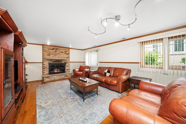 7542 Mason Ave, Burbank, IL 60459 - living room featuring wainscoting, a fireplace, crown molding, healthy amount of natural light, and wood finished floors