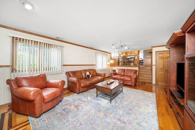7542 Mason Ave, Burbank, IL 60459 - living room featuring light wood-style flooring, crown molding, and wainscoting