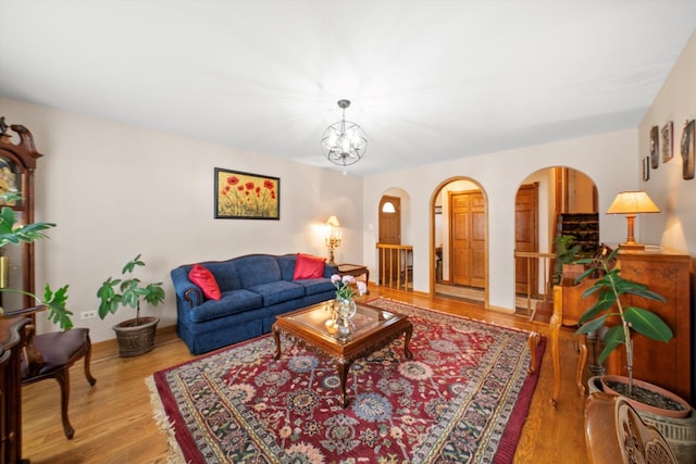 7542 Mason Ave, Burbank, IL 60459 - living room with arched walkways, wood finished floors, and a chandelier