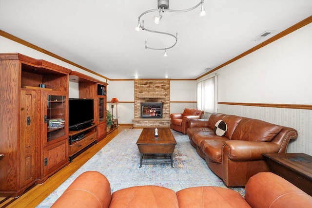 7542 Mason Ave, Burbank, IL 60459 - living area with light wood finished floors, wainscoting, a brick fireplace, and ornamental molding