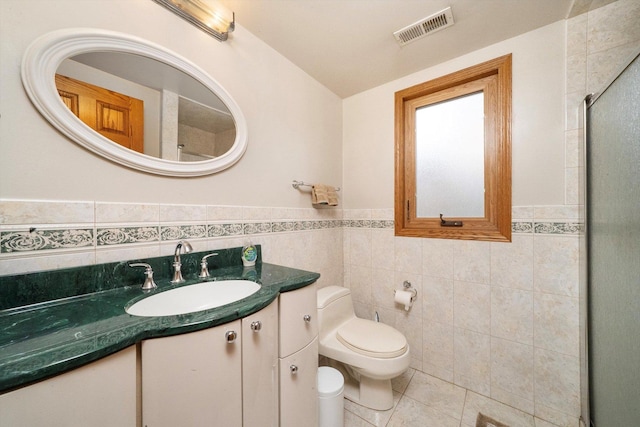 7542 Mason Ave, Burbank, IL 60459 - full bathroom with tile walls, tile patterned floors, a stall shower, vanity, and a wainscoted wall