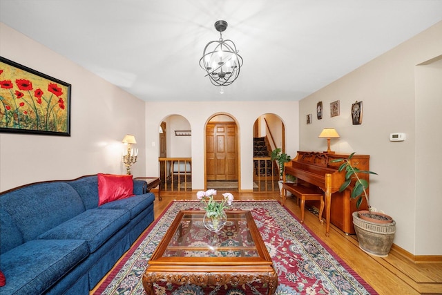7542 Mason Ave, Burbank, IL 60459 - living area featuring arched walkways, wood finished floors, and a chandelier