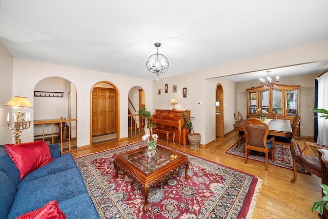 7542 Mason Ave, Burbank, IL 60459 - living room featuring arched walkways, a chandelier, and wood finished floors