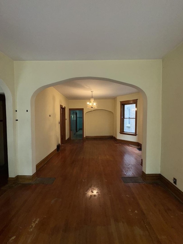 2130 W Concord Pl, Chicago, IL 60647 - spare room with wood-type flooring, arched walkways, and a chandelier