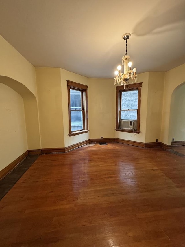 2130 W Concord Pl, Chicago, IL 60647 - spare room with arched walkways, a chandelier, wood finished floors, and cooling unit