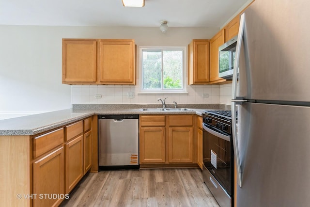 5S730 Malibu Ln, Naperville, IL 60540 - kitchen with appliances with stainless steel finishes, light wood-type flooring, tasteful backsplash, and a peninsula