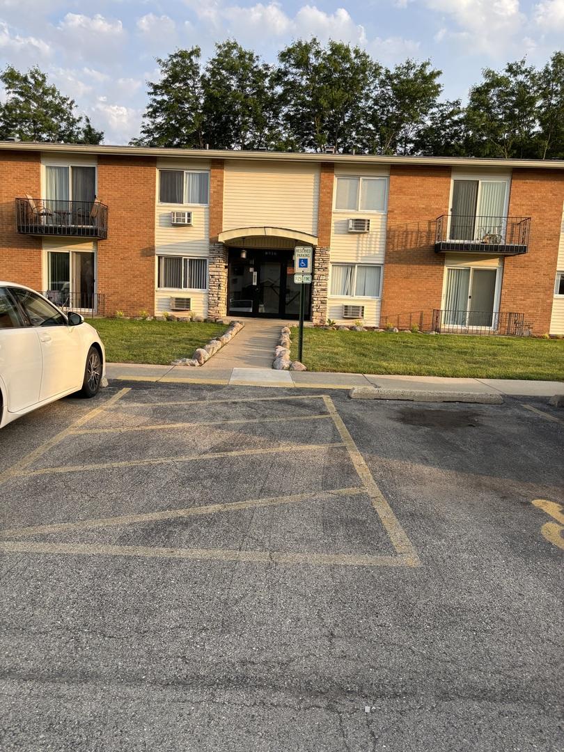 8916 Kenneth Dr Unit 1E, Des Plaines, IL 60016 - view of building exterior with uncovered parking