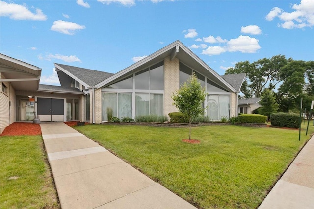 8916 Kenneth Dr Unit 1E, Des Plaines, IL 60016 - view of front of property with concrete driveway, a front yard, and brick siding