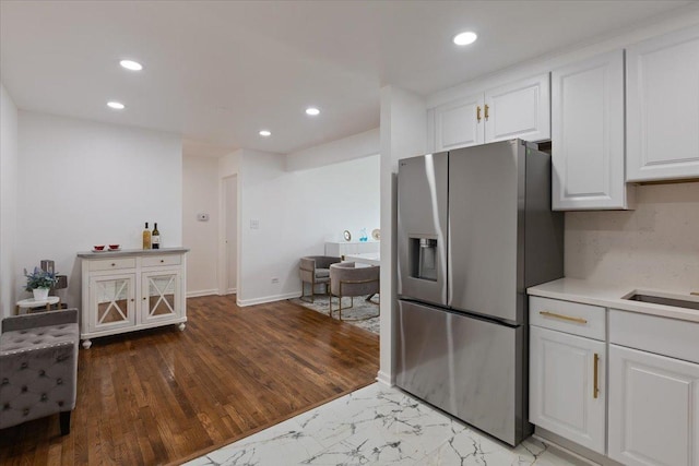 8916 Kenneth Dr Unit 1E, Des Plaines, IL 60016 - kitchen with stainless steel fridge with ice dispenser, white cabinets, light countertops, recessed lighting, and marble look tiles
