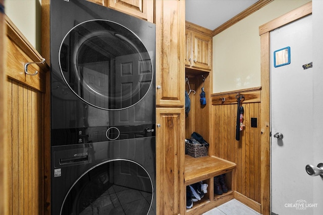 189 Cross St, Sugar Grove, IL 60554 - washroom featuring estacked washer and dryer, cabinet space, crown molding, a wainscoted wall, and tile patterned floors