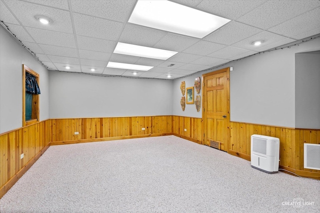 189 Cross St, Sugar Grove, IL 60554 - carpeted empty room featuring a wainscoted wall, wood walls, and a paneled ceiling