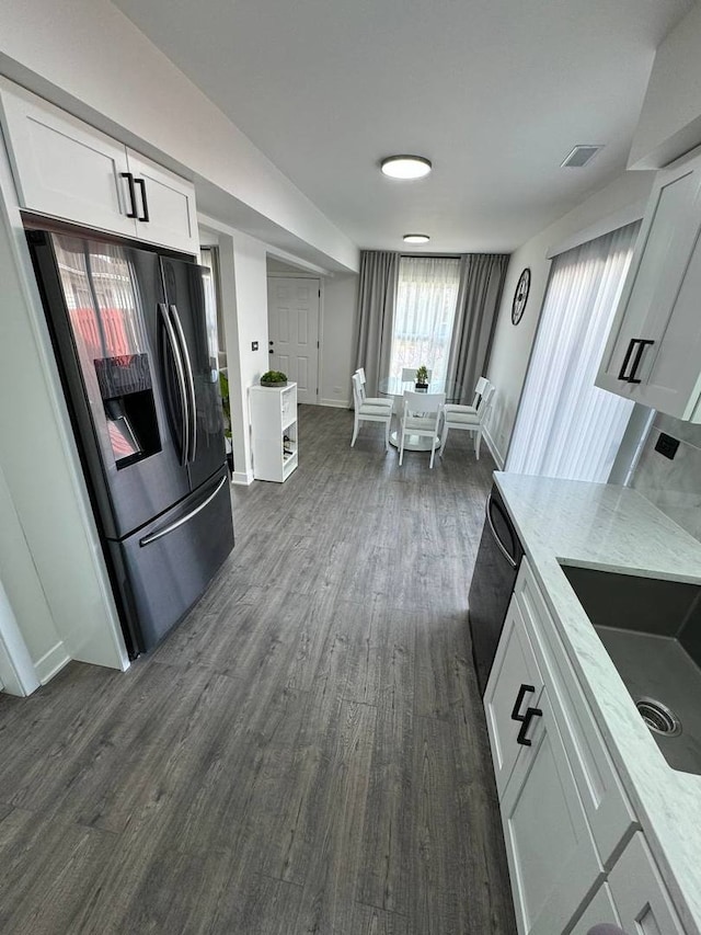 1805 Marquette Ln, Hoffman Estates, IL 60169 - kitchen featuring stainless steel refrigerator with ice dispenser, white cabinets, light stone countertops, and dark wood-style floors