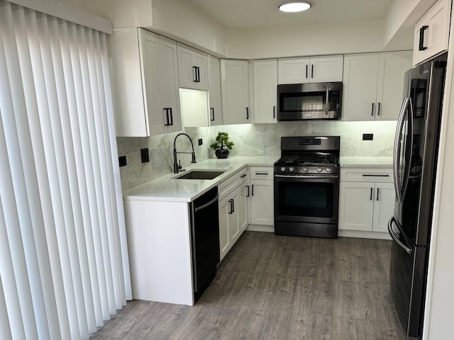 1805 Marquette Ln, Hoffman Estates, IL 60169 - kitchen with stainless steel microwave, range with gas cooktop, freestanding refrigerator, black dishwasher, and white cabinetry