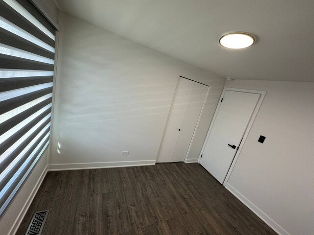 1805 Marquette Ln, Hoffman Estates, IL 60169 - unfurnished bedroom featuring dark wood-style floors and baseboards