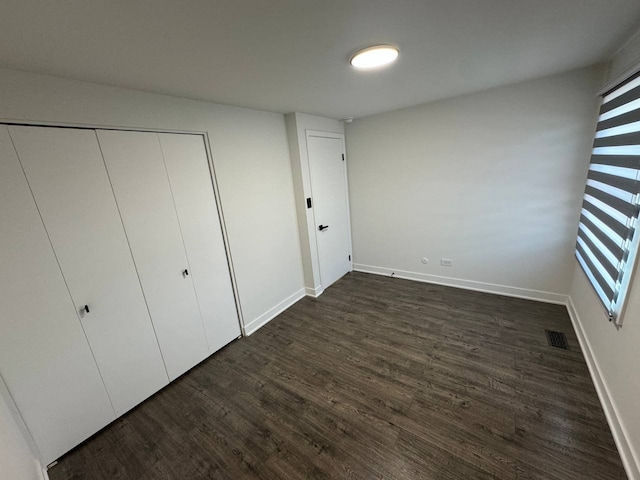 1805 Marquette Ln, Hoffman Estates, IL 60169 - unfurnished bedroom with dark wood-style flooring and a closet