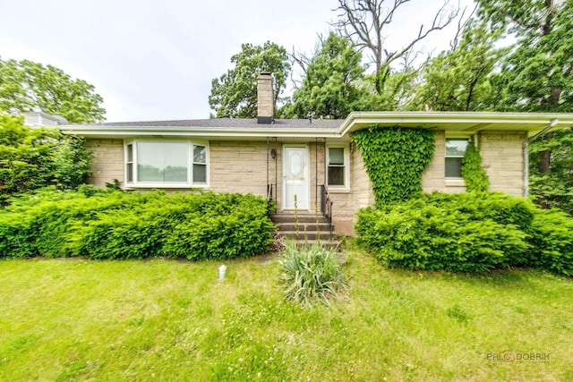 38W333 Oakwood Dr, Saint Charles, IL 60175 - view of front of property featuring stone siding, a chimney, entry steps, and a front lawn