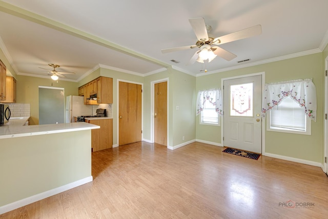 38W333 Oakwood Dr, Saint Charles, IL 60175 - kitchen with a ceiling fan, decorative backsplash, freestanding refrigerator, light wood-style flooring, and crown molding