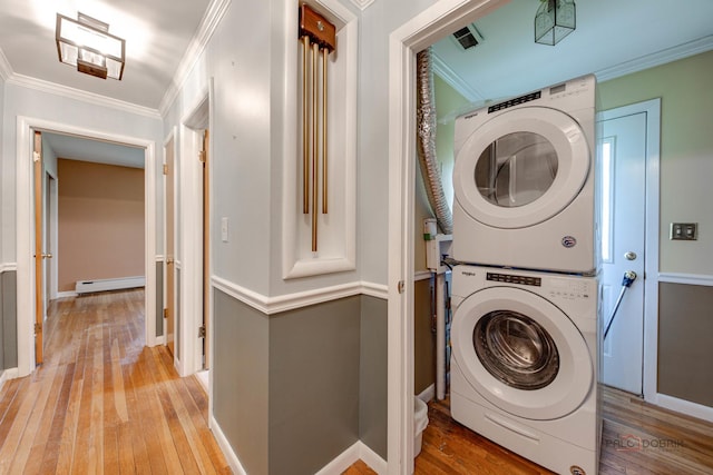 38W333 Oakwood Dr, Saint Charles, IL 60175 - laundry room with stacked washer and clothes dryer, a baseboard heating unit, light wood finished floors, and ornamental molding