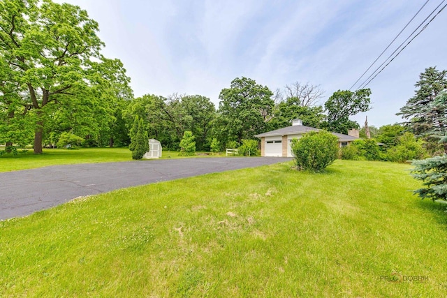 38W333 Oakwood Dr, Saint Charles, IL 60175 - view of front of property featuring a shed, a front yard, a garage, and a chimney