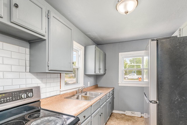 148 E Francis Rd, New Lenox, IL 60451 - kitchen featuring stainless steel appliances, gray cabinetry, decorative backsplash, and light countertops