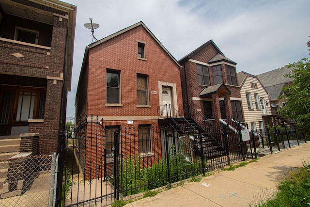 1044 W 34th Pl, Chicago, IL 60608 - multi unit property with a fenced front yard, brick siding, and a gate
