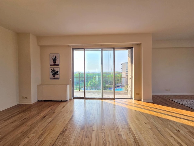 6833 N Kedzie Ave Unit 816, Chicago, IL 60645 - spare room featuring wood-type flooring and baseboards