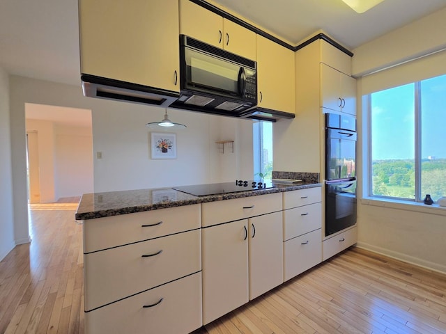 6833 N Kedzie Ave Unit 816, Chicago, IL 60645 - kitchen featuring black appliances, light wood-type flooring, dark stone countertops, white cabinets, and a peninsula