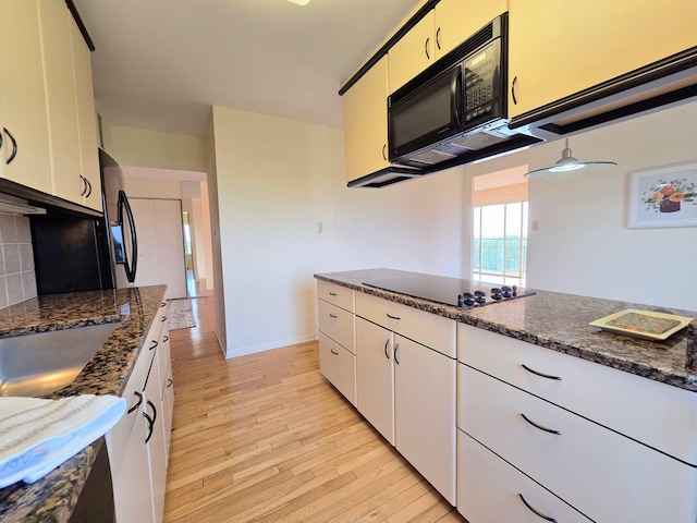 6833 N Kedzie Ave Unit 816, Chicago, IL 60645 - kitchen with black appliances, white cabinetry, light wood-style floors, and dark stone counters
