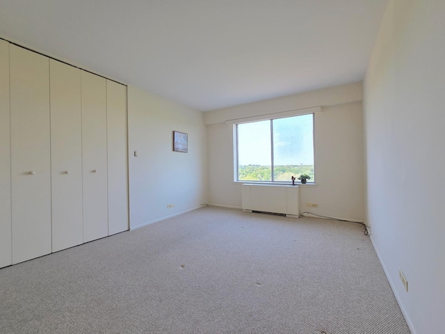 6833 N Kedzie Ave Unit 816, Chicago, IL 60645 - unfurnished bedroom with radiator, light colored carpet, and a closet