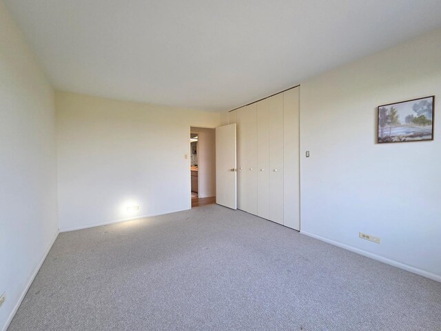 6833 N Kedzie Ave Unit 816, Chicago, IL 60645 - unfurnished bedroom featuring light colored carpet and a closet