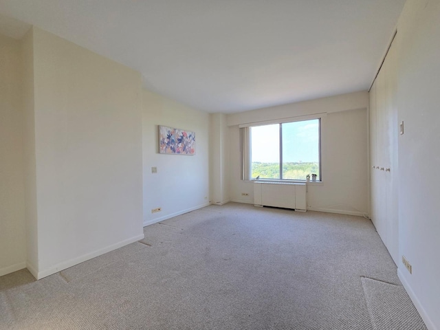 6833 N Kedzie Ave Unit 816, Chicago, IL 60645 - spare room featuring radiator and light colored carpet
