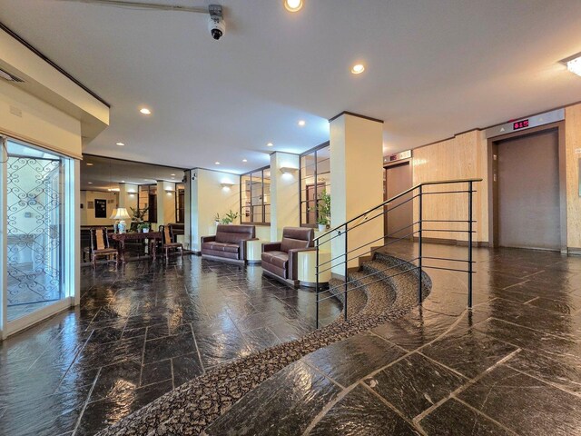 6833 N Kedzie Ave Unit 816, Chicago, IL 60645 - community lobby with recessed lighting, stairway, and a surveillance system
