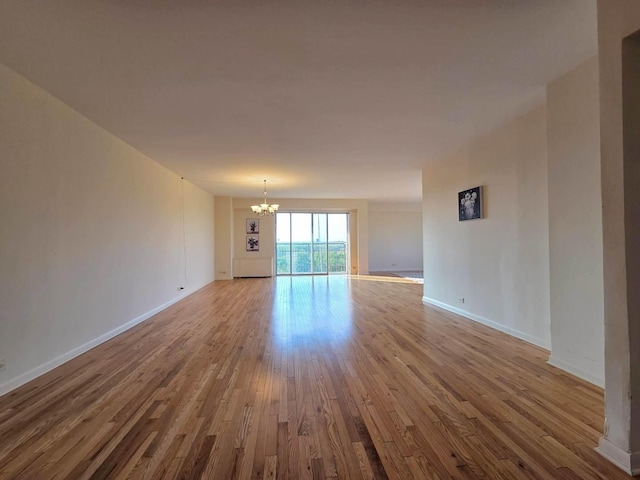 6833 N Kedzie Ave Unit 816, Chicago, IL 60645 - empty room with a chandelier and wood finished floors