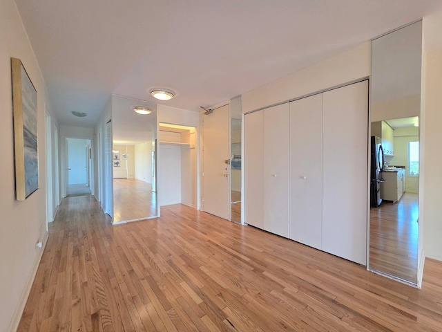 6833 N Kedzie Ave Unit 816, Chicago, IL 60645 - unfurnished bedroom featuring freestanding refrigerator, light wood-style flooring, and multiple closets