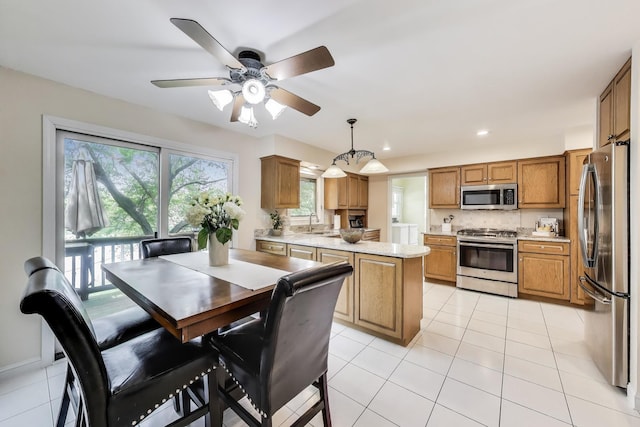 4116 N Terramere Ave, Arlington Heights, IL 60004 - kitchen featuring appliances with stainless steel finishes, brown cabinets, light tile patterned flooring, decorative light fixtures, and recessed lighting