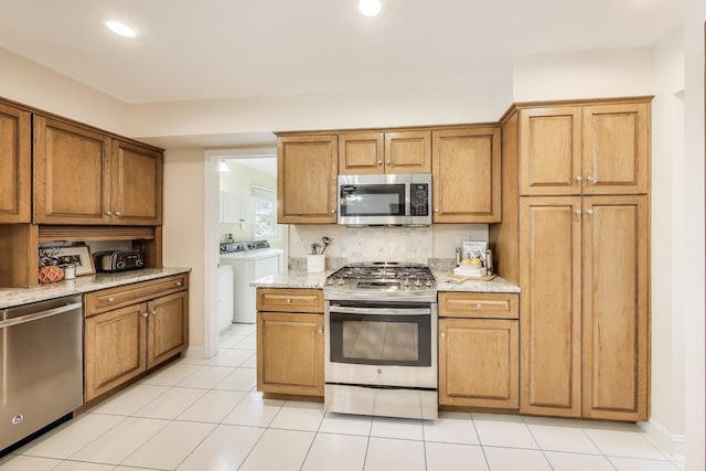 4116 N Terramere Ave, Arlington Heights, IL 60004 - kitchen featuring stainless steel appliances, separate washer and dryer, brown cabinetry, light stone counters, and recessed lighting