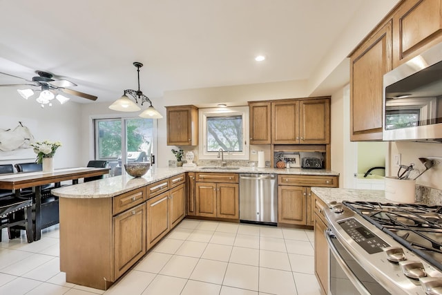 4116 N Terramere Ave, Arlington Heights, IL 60004 - kitchen with stainless steel appliances, brown cabinets, a peninsula, and light stone countertops