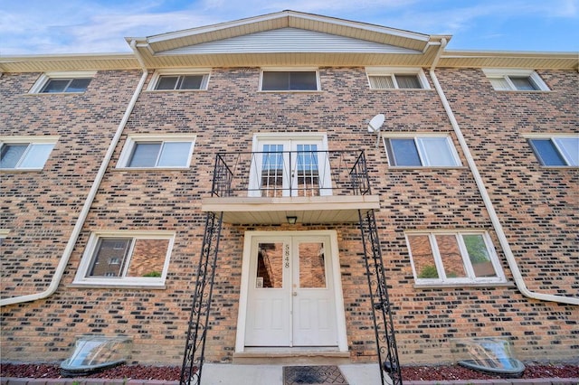 5848 W 76th Pl N Unit 203, Burbank, IL 60459 - view of front of home featuring a balcony, brick siding, and french doors