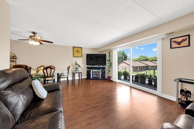 5848 W 76th Pl N Unit 203, Burbank, IL 60459 - living area featuring wood finished floors, a ceiling fan, and a textured ceiling