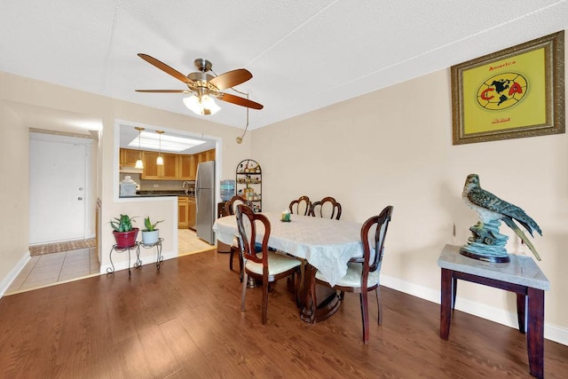 5848 W 76th Pl N Unit 203, Burbank, IL 60459 - dining area featuring a ceiling fan and light wood finished floors