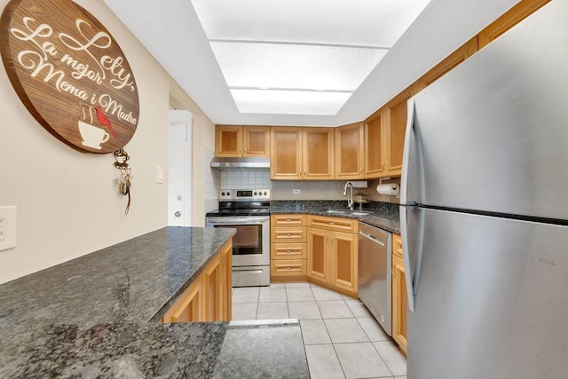 5848 W 76th Pl N Unit 203, Burbank, IL 60459 - kitchen featuring stainless steel appliances, under cabinet range hood, light tile patterned floors, backsplash, and dark stone countertops