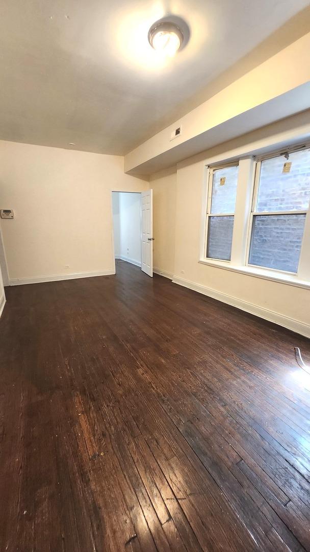 6938 S Michigan Ave, Chicago, IL 60637 - empty room featuring hardwood / wood-style floors and baseboards