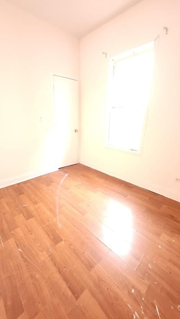 6938 S Michigan Ave, Chicago, IL 60637 - empty room featuring wood finished floors and baseboards