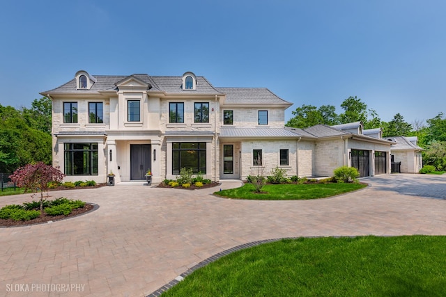 219 Lincoln Dr, Glencoe, IL 60022 - french country home featuring curved driveway and an attached garage