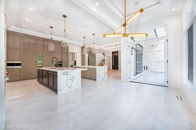 219 Lincoln Dr, Glencoe, IL 60022 - kitchen featuring a spacious island, modern cabinets, decorative light fixtures, ornamental molding, and french doors