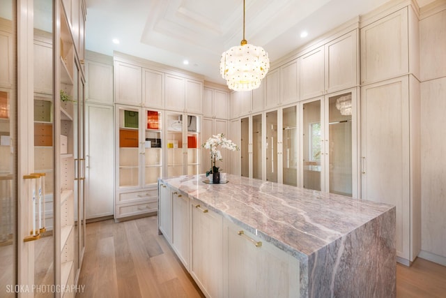 219 Lincoln Dr, Glencoe, IL 60022 - walk in closet with light wood-type flooring, a chandelier, and a raised ceiling