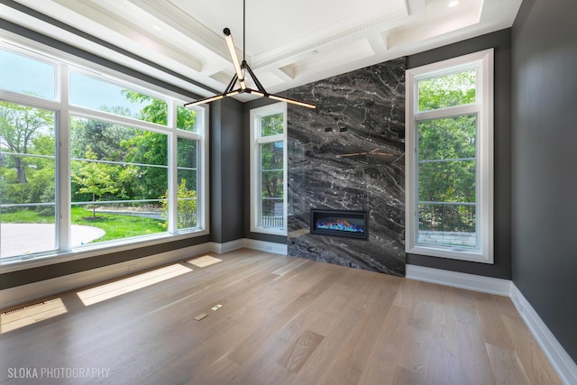 219 Lincoln Dr, Glencoe, IL 60022 - unfurnished living room featuring wood finished floors, a chandelier, and healthy amount of natural light