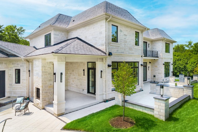 219 Lincoln Dr, Glencoe, IL 60022 - back of house featuring stone siding and a patio area