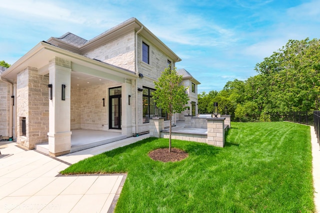219 Lincoln Dr, Glencoe, IL 60022 - rear view of property featuring stone siding and a patio